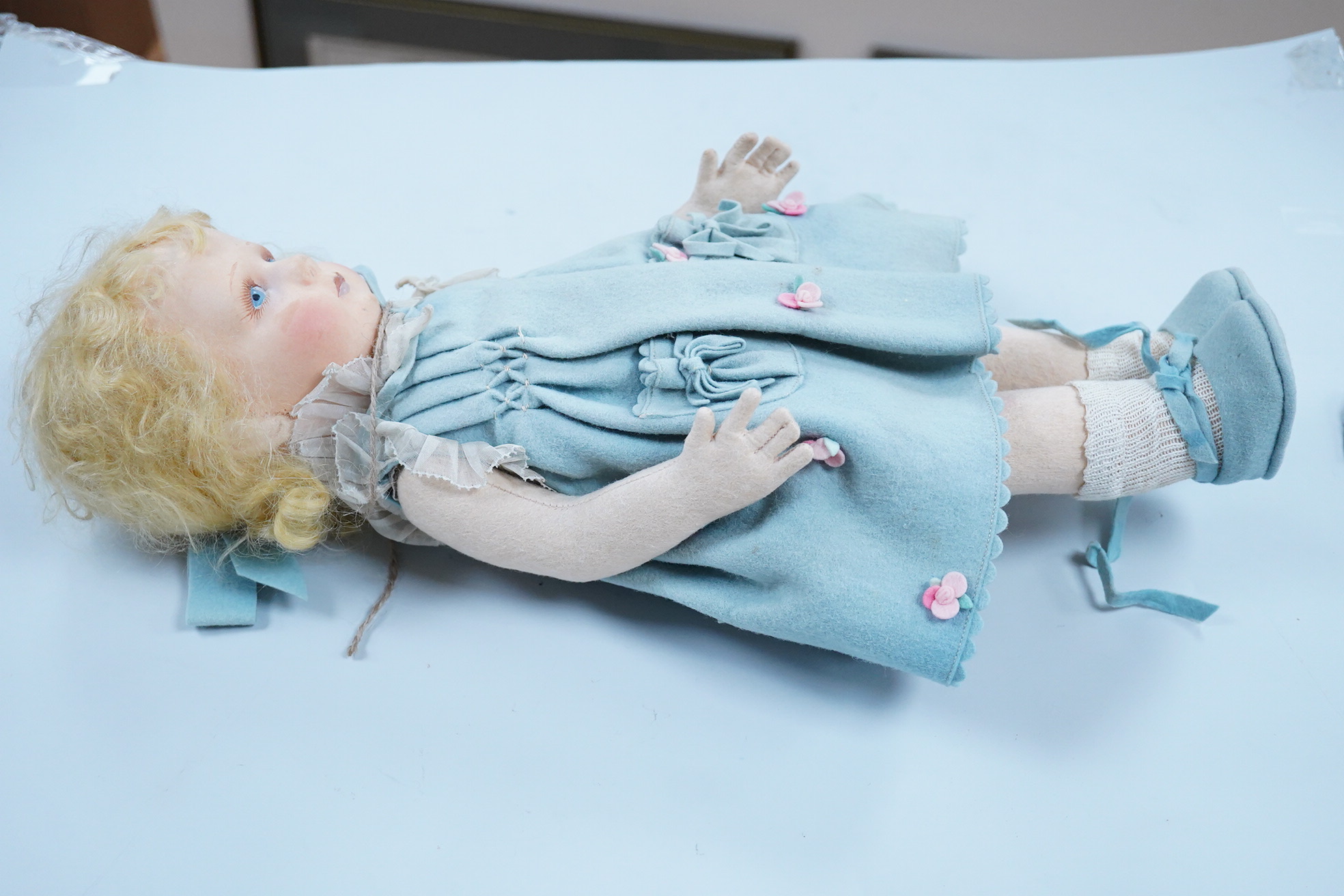 A wool felt Lenci doll with painted features to the face, 42cm long